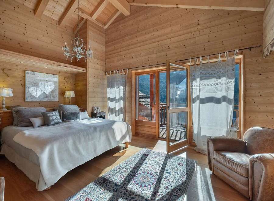 Experience the ultimate alpine retreat in this charming wooden chalet bedroom.
