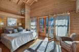 Experience the ultimate alpine retreat in this charming wooden chalet bedroom.