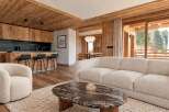 Experience luxurious mountain living in this beautifully appointed living space, featuring a plush cream sofa and a cozy armchair perfect for relaxation.