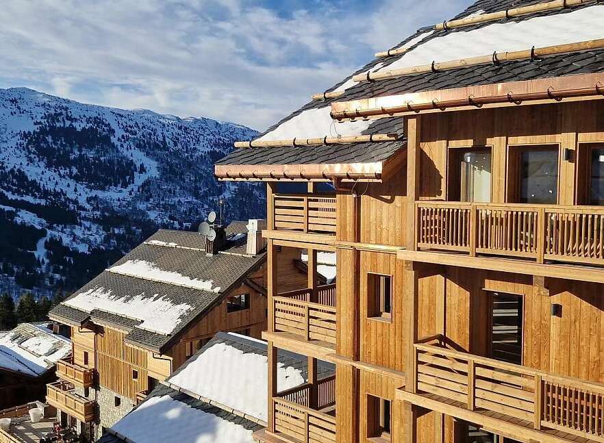 Experience luxury mountain living in this stunning wooden chalet, nestled amidst snow-capped peaks.