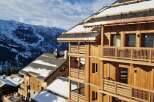 Experience luxury mountain living in this stunning wooden chalet, nestled amidst snow-capped peaks.