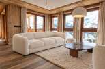 Experience luxurious mountain living in this beautifully appointed living room, featuring a plush cream sofa and a striking marble coffee table.