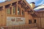 Experience the rustic charm of this timber-framed building, featuring a stone facade with the prominent 'LEBOIS DES OURS' signage.