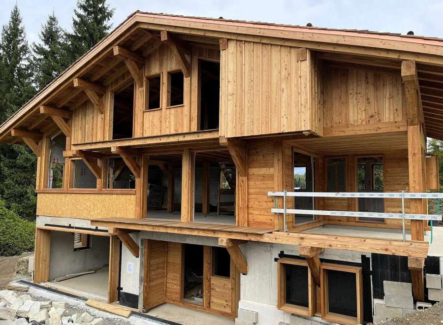 Experience the charm of this unfinished wooden chalet, showcasing exposed beams and a multi-level design.
