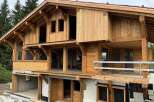 Experience the charm of this unfinished wooden chalet, showcasing exposed beams and a multi-level design.