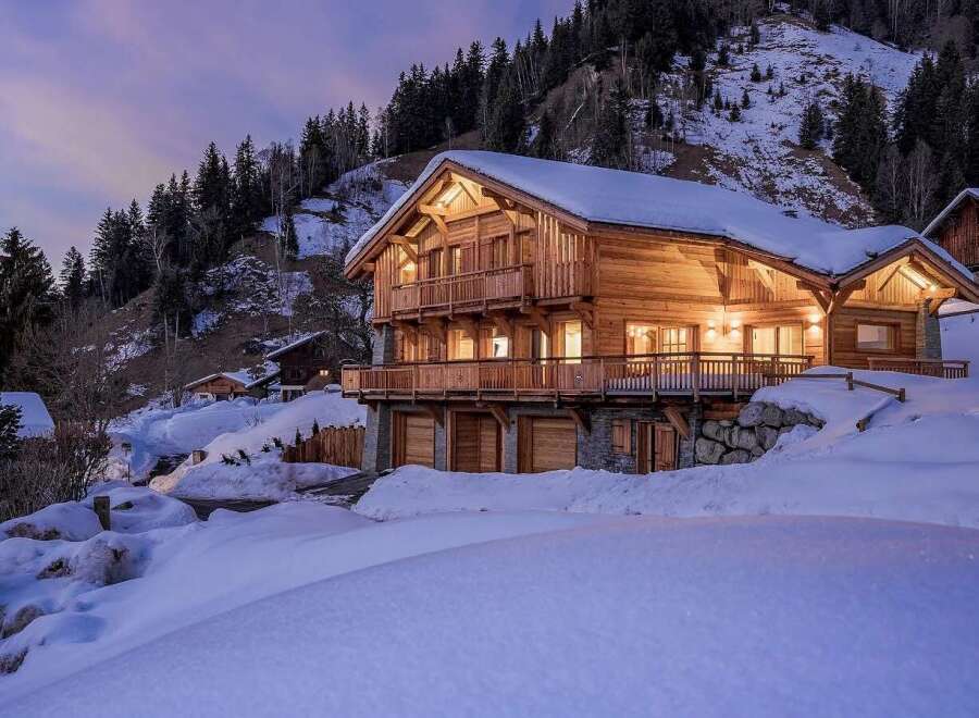 Experience the ultimate alpine retreat in this stunning wooden chalet, nestled amidst snow-covered mountains.