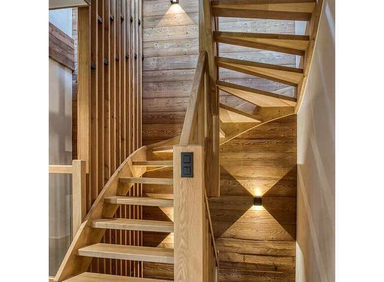 Ascend to luxury in this stunning chalet, featuring a beautifully crafted wooden staircase that serves as the heart of the home.
