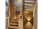 Ascend to luxury in this stunning chalet, featuring a beautifully crafted wooden staircase that serves as the heart of the home.