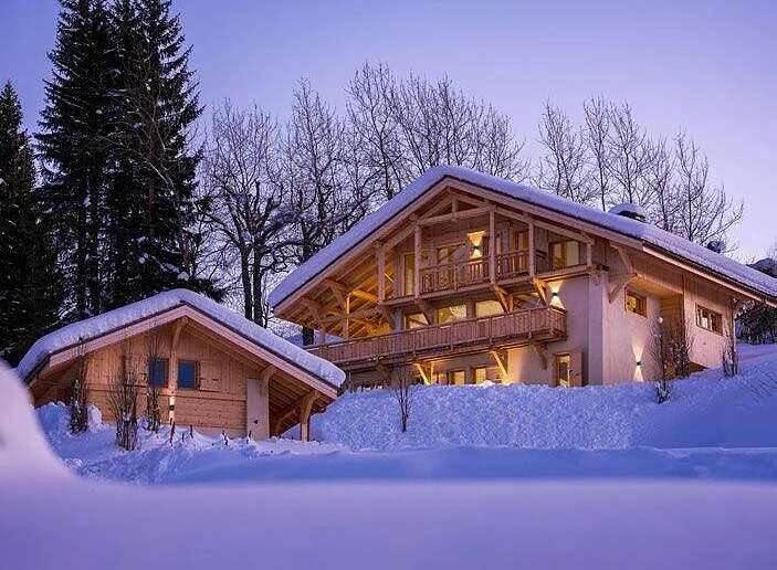 Experience the epitome of alpine luxury in this stunning chalet, nestled amidst snow-covered trees.