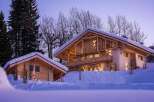 Experience the epitome of alpine luxury in this stunning chalet, nestled amidst snow-covered trees.