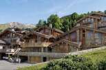 Experience luxury mountain living in this stunning chalet, featuring a harmonious blend of natural stone and warm wood architecture.