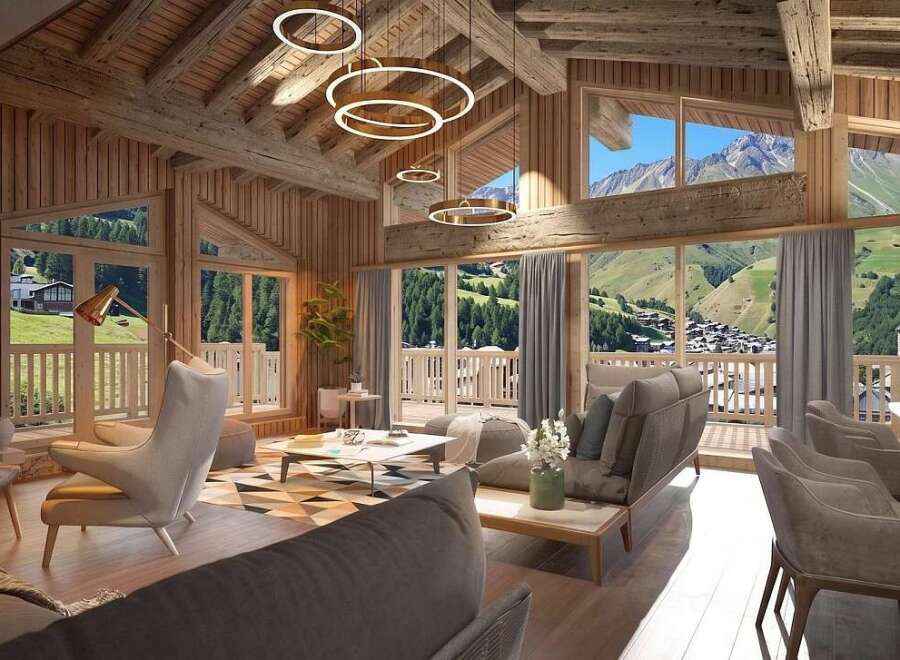 Experience luxury mountain living in this stunning chalet, featuring a warm, wood-paneled interior with exposed beams and modern circular pendant lights.