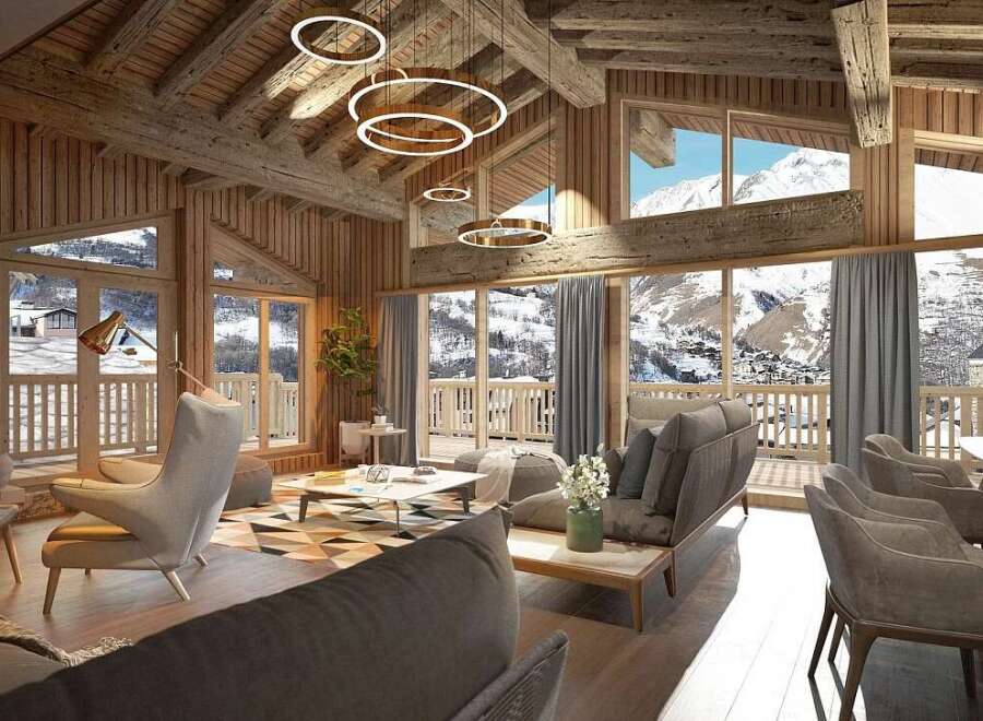 Experience luxurious mountain living in this stunning chalet, featuring a cozy fireplace and expansive windows offering breathtaking alpine views.