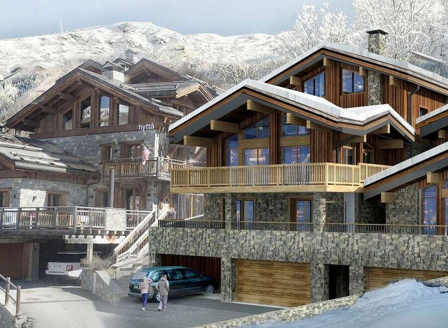 Experience luxury mountain living in this stunning chalet, featuring a blend of rustic stone and warm wood architecture.