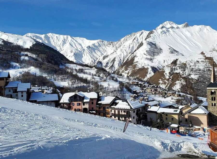 Experience the charm of alpine living in this picturesque ski village, nestled amidst majestic snow-capped mountains.