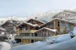 Experience luxury mountain living in this stunning chalet, featuring a harmonious blend of natural stone and warm wood accents.
