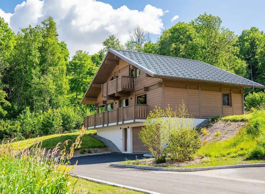 Experience serene living in this stunning wooden chalet nestled amidst lush greenery.