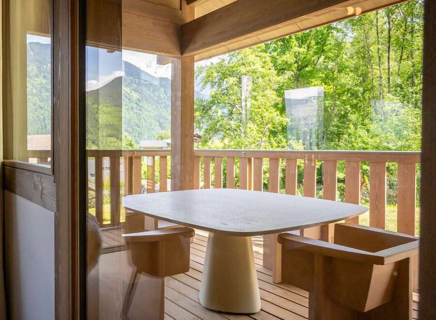 Enjoy your morning coffee or evening drinks on this charming balcony, complete with a stylish table and seating.