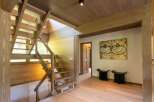 Experience rustic charm and modern design in this stunning home featuring a beautiful wooden staircase that leads to the upper levels.