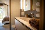 Experience modern comfort in this beautifully appointed bathroom, featuring a sleek vanity with an integrated sink and a stylish chrome faucet.