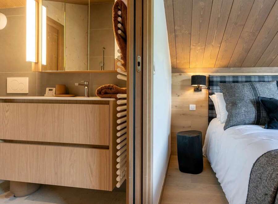 Experience modern comfort in this beautifully appointed room, featuring a sleek bathroom vanity with ample storage and a luxurious bedroom area.