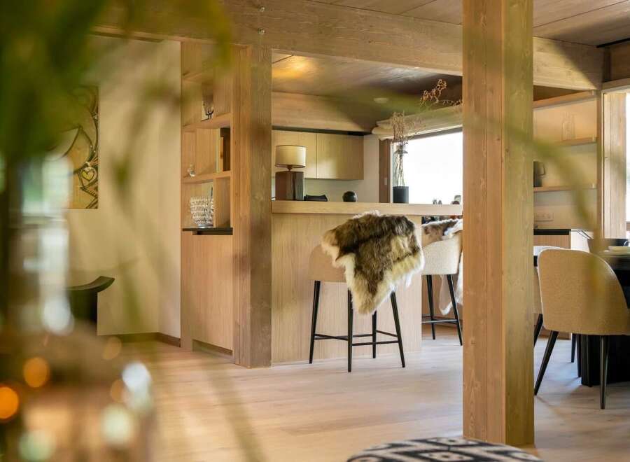 Experience modern living in this beautifully appointed open-plan space, featuring a sleek kitchen island with bar stools perfect for casual dining.
