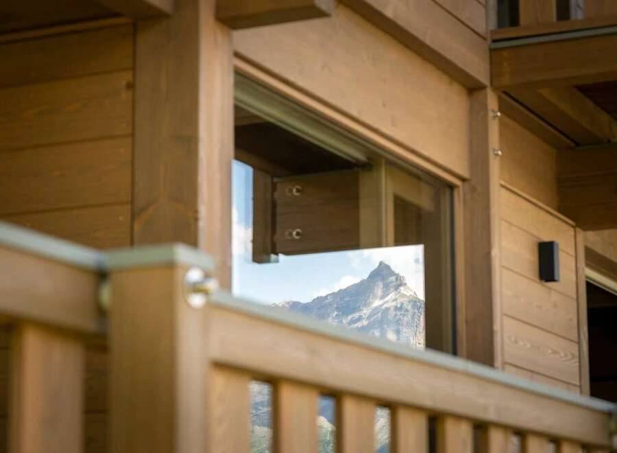 Experience the breathtaking mountain views from this charming wooden cabin.
