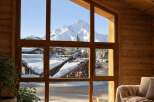 Experience breathtaking mountain views from this stunning property, featuring expansive windows that frame a majestic snow-capped peak.