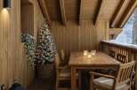 Experience cozy winter evenings on this charming wooden deck, complete with a festive Christmas tree and warm ambient lighting.
