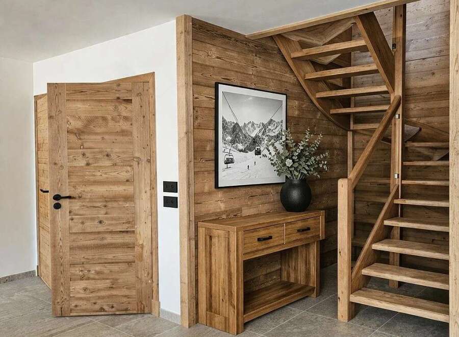 Experience rustic charm and modern comfort in this inviting entryway, featuring warm wooden doors and a stunning wooden staircase.