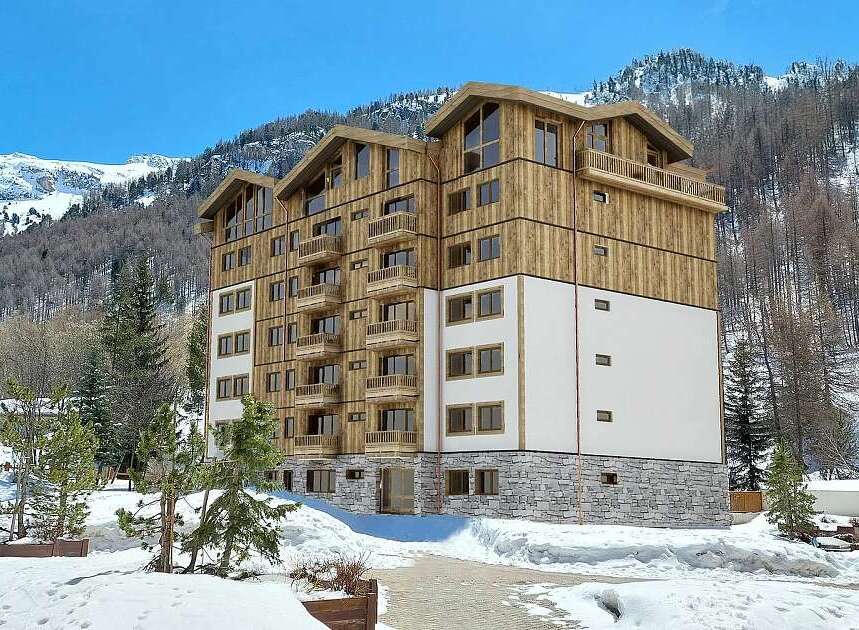 Experience luxury mountain living in this stunning multi-story residence, featuring a modern design with warm wood accents and expansive balconies perfect for enjoying breathtaking alpine views.