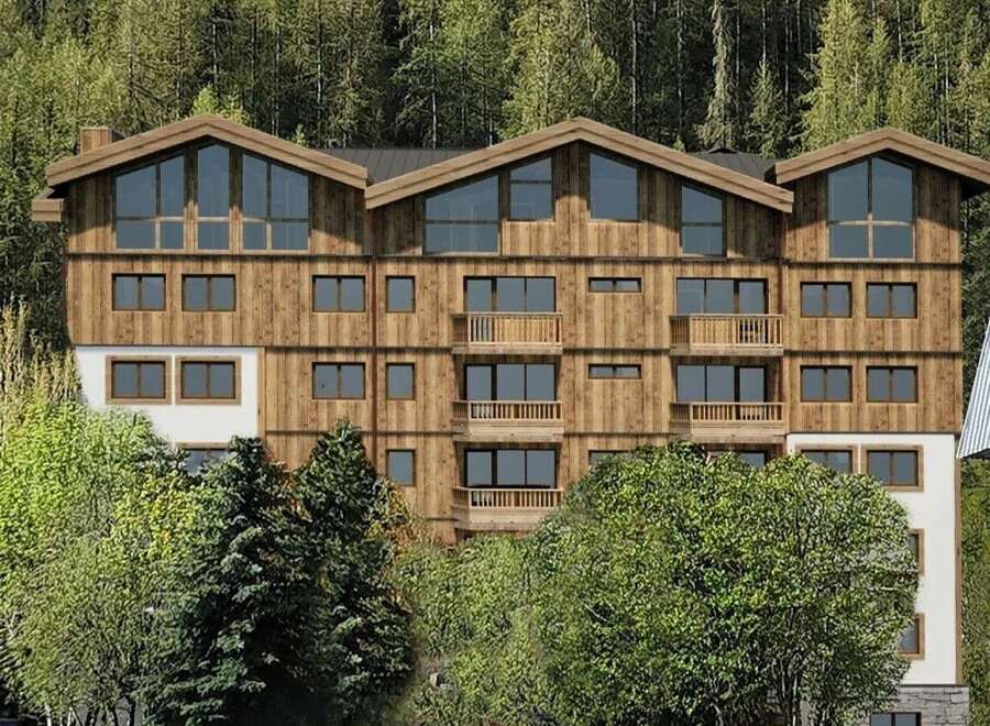 Discover this stunning multi-story wooden building nestled amidst a lush forest.