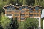 Discover this stunning multi-story wooden building nestled amidst a lush forest.