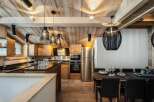 Experience luxury mountain living in this stunning chalet kitchen and dining area.