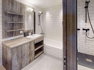 This modern bathroom features a sleek vanity with ample storage and a minimalist sink.