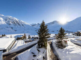 Experience the ultimate winter wonderland from this stunning property nestled amidst snow-capped mountains.
