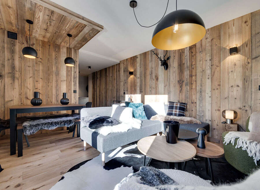 Experience rustic luxury in this beautifully appointed living space, featuring warm, natural wood paneling throughout.