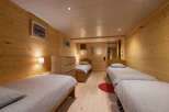 This charming bedroom features three comfortable twin beds, perfect for accommodating family or guests.