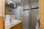 This charming bathroom features a spacious walk-in shower with glass doors, perfect for a refreshing start to your day.