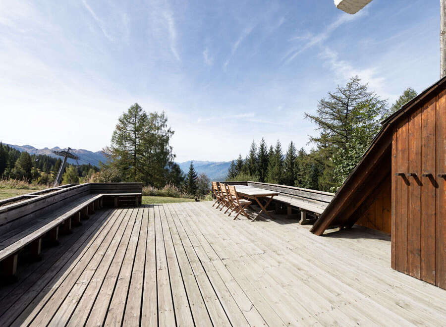 Enjoy breathtaking mountain views from this expansive wooden deck, perfect for outdoor dining and relaxation.