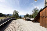 Enjoy breathtaking mountain views from this expansive wooden deck, perfect for outdoor dining and relaxation.