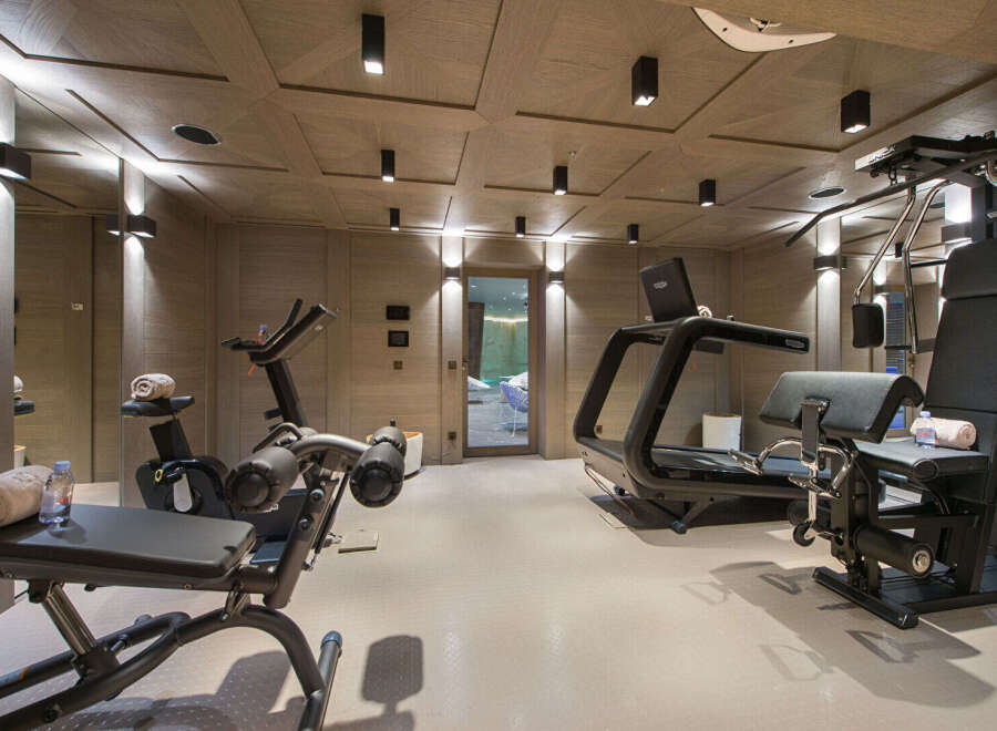 Elevate your fitness routine in this luxurious home gym, featuring state-of-the-art cardio equipment like treadmills and stationary bikes.