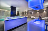 Experience ultimate relaxation in this luxurious spa featuring a vibrant blue-lit jacuzzi and a refreshing ice bath.