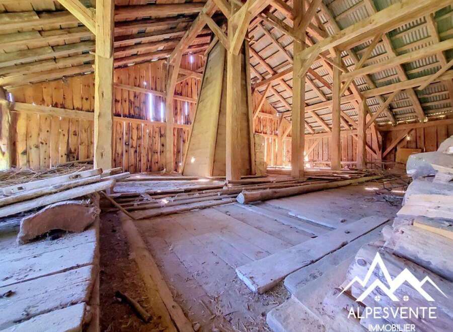 Discover the rustic charm of this unfinished barn, featuring exposed wooden beams and a spacious open floor plan.