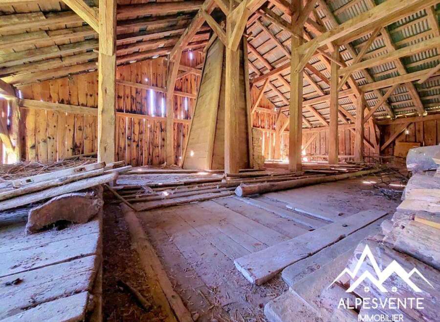 Discover the rustic charm of this unfinished barn, featuring exposed wooden beams and a spacious open floor plan.