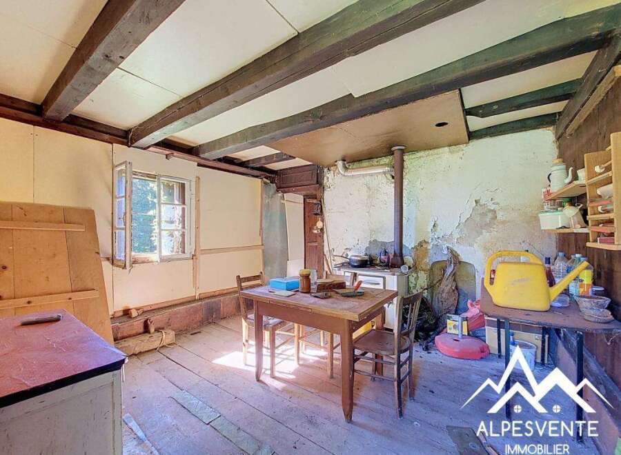 This rustic interior features exposed wooden beams and a charming country kitchen.