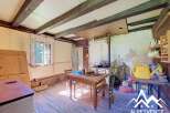 This rustic interior features exposed wooden beams and a charming country kitchen.