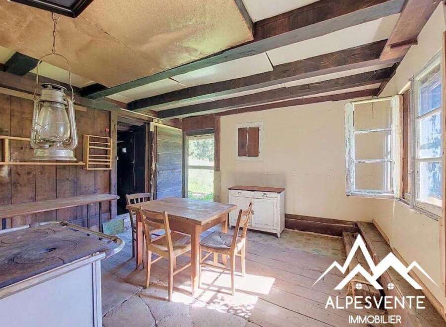 Step into a rustic charm with this unique property, featuring exposed wooden beams and a vintage hanging lantern that adds a touch of old-world character.