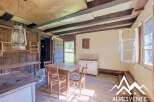 Step into a rustic charm with this unique property, featuring exposed wooden beams and a vintage hanging lantern that adds a touch of old-world character.