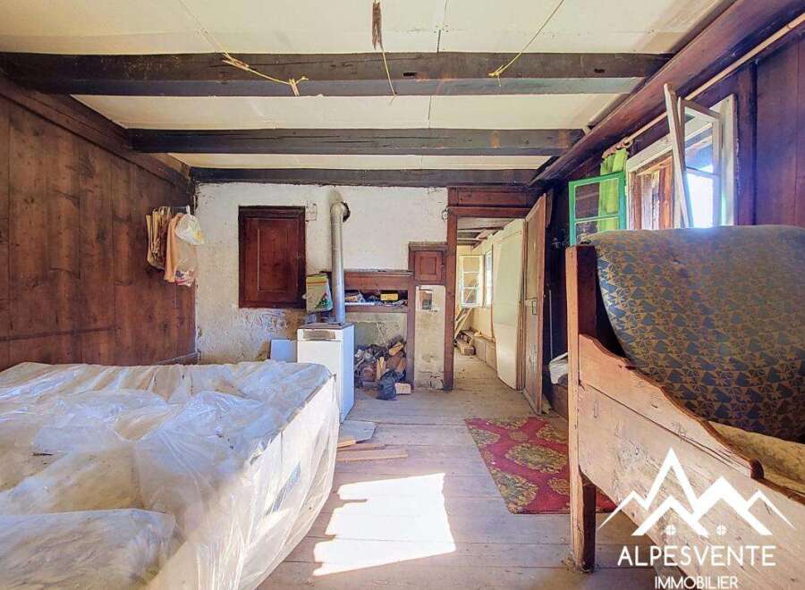 Step into a rustic charm with this unique property, featuring exposed wooden beams and traditional wood-paneled walls that evoke a sense of history and warmth.
